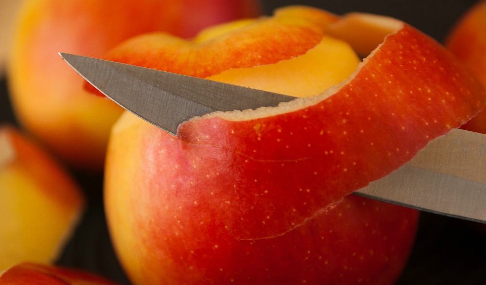 peeling a red apple